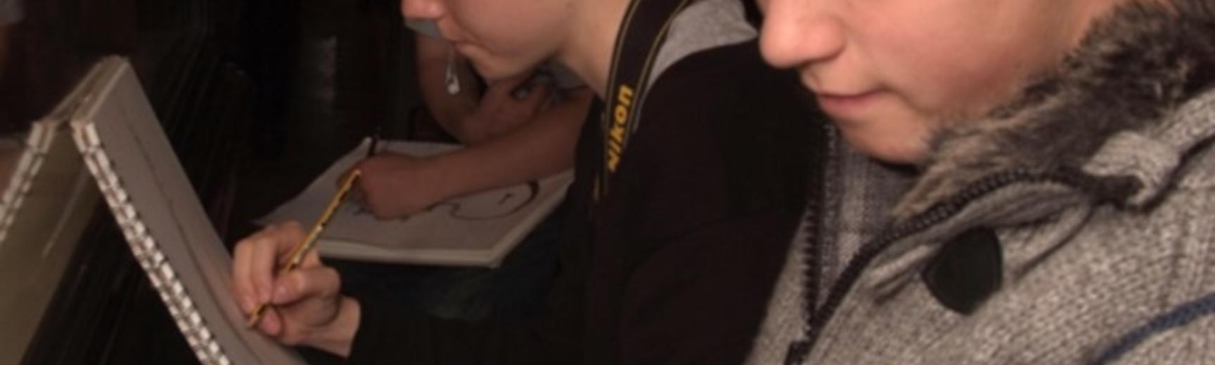 Secondary school session sketching objects in the Pitt Rivers museum