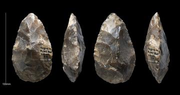Carved flint tools on black background